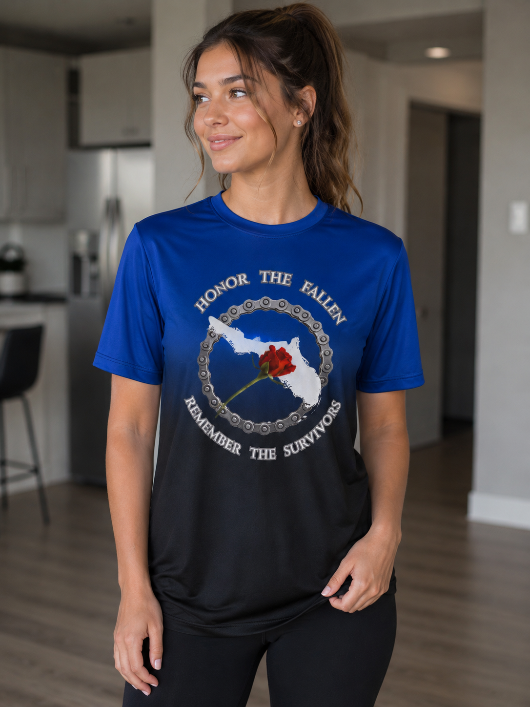Woman wearing a blue and black memorial t-shirt with a rose graphic.