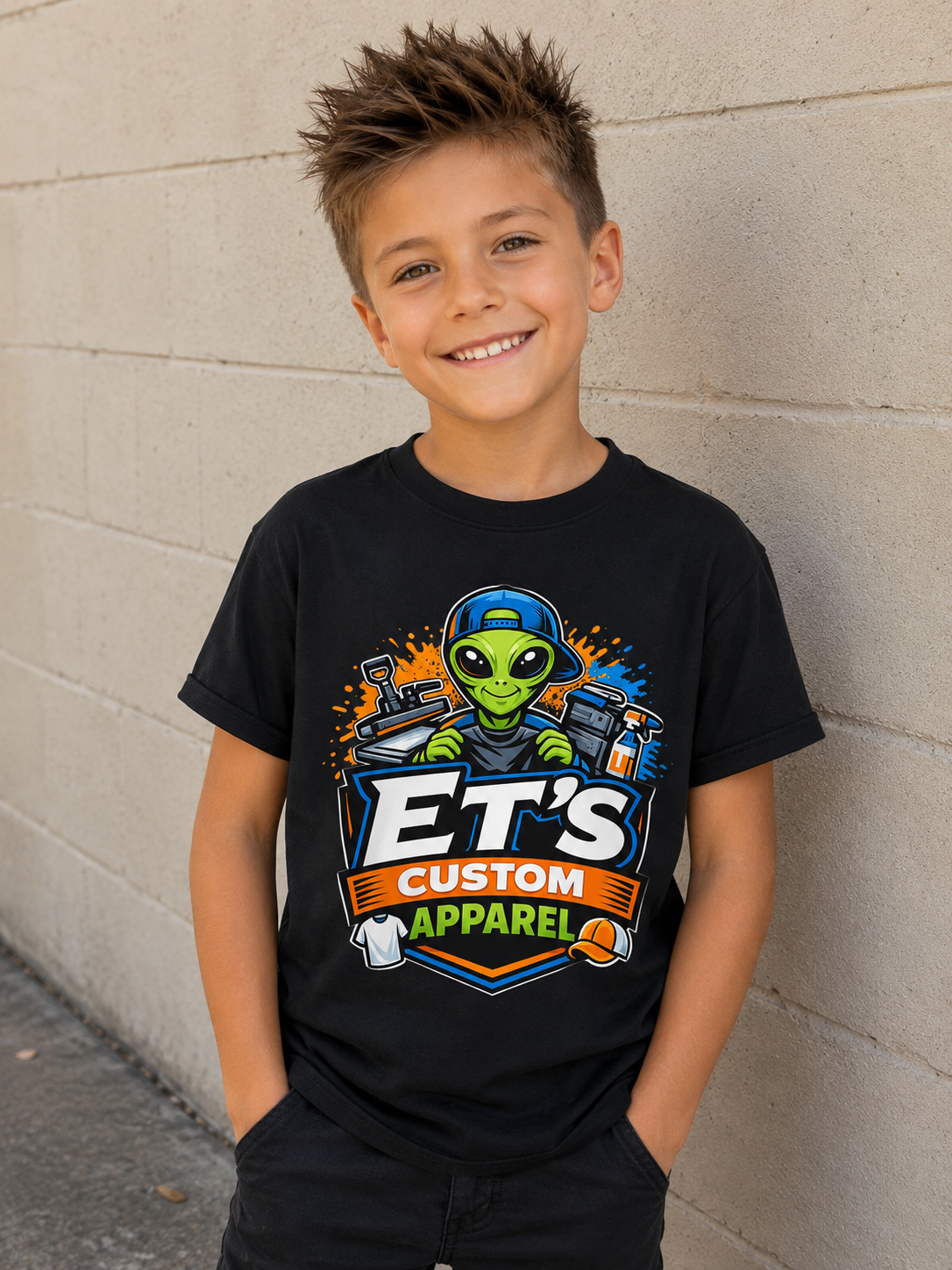 Boy wearing custom black ET'S Custom Apparel alien graphic t-shirt.
