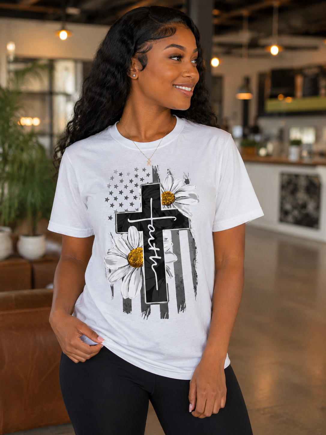 Woman wearing a white custom faith-themed t-shirt with floral artwork.
